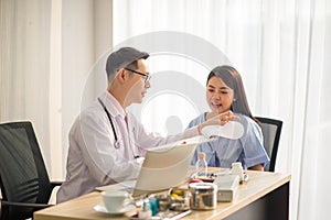 Asian Doctor and patient talking and checking  health care medical sickness at hospital