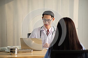 Asian Doctor and patient talking and checking  health care medical sickness at hospital