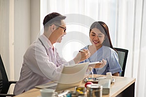 Asian Doctor and patient talking and checking  health care medical sickness at hospital