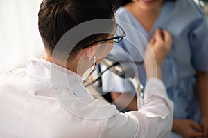 Asian Doctor and patient talking and checking  health care medicall sickness at hospital