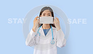 Asian doctor wearing a protective mask with `stay safe` text message