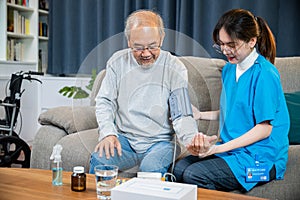 Asian doctor woman examine do checking old man client heart rate with pulsimeter