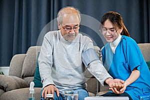 Asian doctor woman examine do checking old man client heart rate with pulsimeter monitor