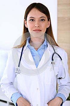Asian doctor woman happy and cheerful while standing in hospital office. Medicine and health care concept
