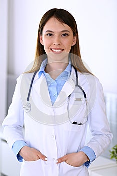 Asian doctor woman happy and cheerful while standing in hospital office. Medicine and health care concept