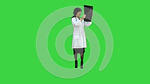 Asian doctor woman look at digital tablet on a Green Screen, Chroma Key