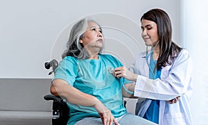 Asian doctor woman Using a stethoscope Listen to heart rate of elderly woman patients to check for heart disease
