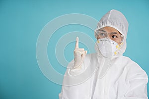 Asian doctors or nurses pointing fingers upward in protective clothing with masks, rubber gloves and goggles