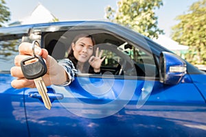 Asian driver woman smiling showing car keys