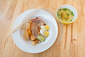 Asian dry noodle with garnish on the wooden background