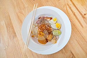 Asian dry noodle with garnish on the wooden background
