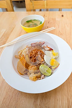 Asian dry noodle with garnish on the wooden background