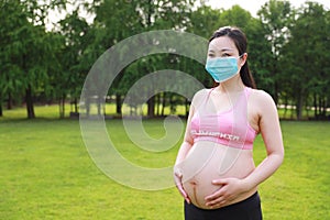 Asian Eastern Chinese happy pregnant woman wear a mask to protect baby from novel coronavirus virus health love concept