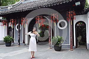 Asian Eastern Chinese young artist player woman carry play violin perform music park garden nature ancient building outdoor nature
