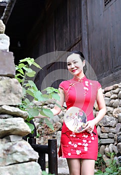 Asian Eastern oriental Chinese woman beauty in traditional ancient dress costume red cheongsam in ancient town old culture fashion