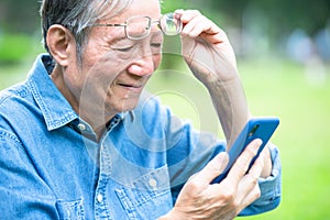 Asian elder man has presbyopia photo