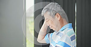 Elder man look through window