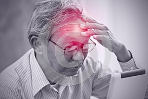 Asian elder pain from headache stress from using tablet