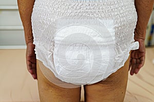 Asian elder senior woman patient wearing adult incontinence diaper pad in hospital