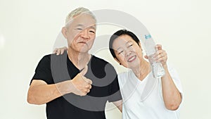 Asian elderly couple encourage drinking water prevent dehydration and improve blood circulation