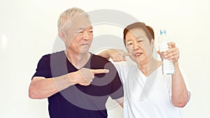 Asian elderly couple encourage drinking water prevent dehydration and improve blood circulation