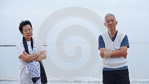 Asian elderly couple fight upset at ocean sea beach morning