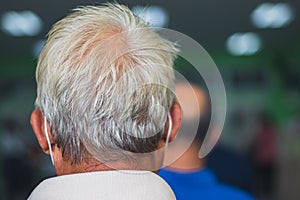 An Asian elderly male back head with black shading gray to white hair with falling problem of glabrous or bald