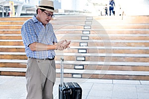 Asian elderly man His hands are kinking due to a nervous system illness and paralysis