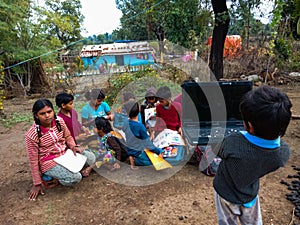 asian kids learning about laptop computer system at open area class in india January 2020