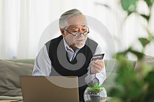 Asian Elderly man use cradit card shopping online