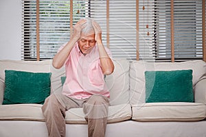 Asian elderly men have headaches Accumulated stress due to being indoors during the Coronavirus 2019.