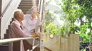 Asian elderly professional couple talking outdoor morning in cit