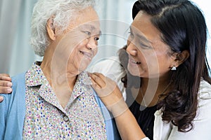 Asian elderly woman with caregiver walking with happy
