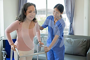 Asian elderly woman doing physiotherapy with nurse support Young woman doing physiotherapy