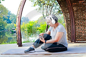 Asian elderly woman exercising in the park in the morning