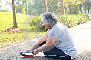 Asian elderly woman exercising in the park in the morning