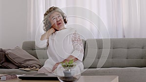 Asian Elderly woman have a headache. On the sofa in the living room