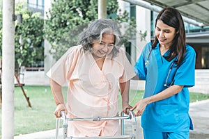 Asian elderly woman patient happy and smile, while doctor holding hands, encouraged and supported to her,