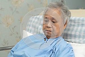 Asian elderly woman patient smile bright face with strong health while lying on bed in hospital, healthy strong medical concept