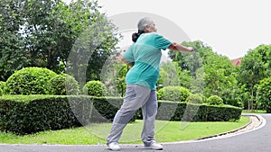 Asian elderly woman Smile, be happy and enjoy exercising in the park.