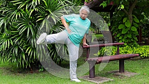 Asian elderly woman Smile, be happy and enjoy exercising in the park.