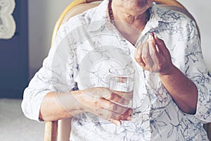 Asian elderly woman are taking and eating medicines and vitamins