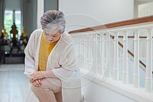 Asian elderly woman walking up stairs have pain knee ache in house. old woman went up stairs. Female old people leg pain and