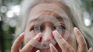 Asian elderly women have eye irritation.