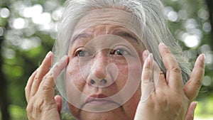 Asian elderly women have eye irritation.