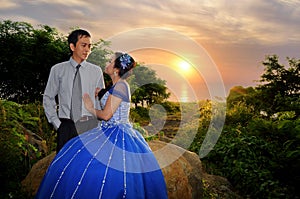 Asian elegance wedding couple ourdoor with sunset backgound