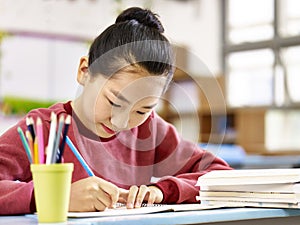 Asian elementary school girl studying in classroom