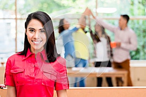 Asian employee happy to be the member of a successful creative team photo