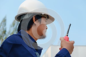Asian engineer in blue safety collar uniform and white security