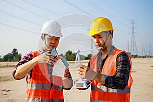 Asian engineer, foreman or leader discussion about home solar cell and wind turbine model in construction site project and High